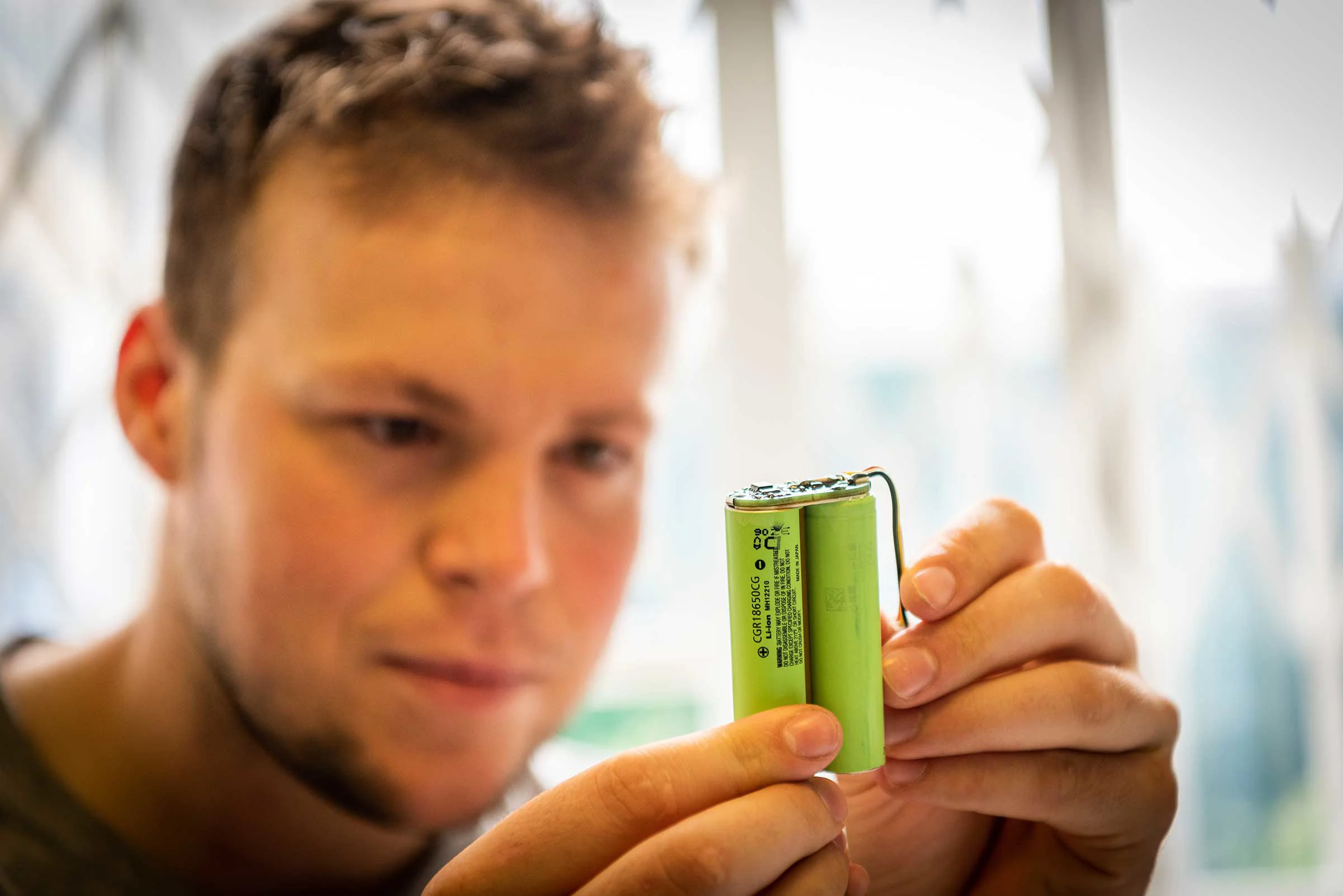 Howard Richard looking at a battery