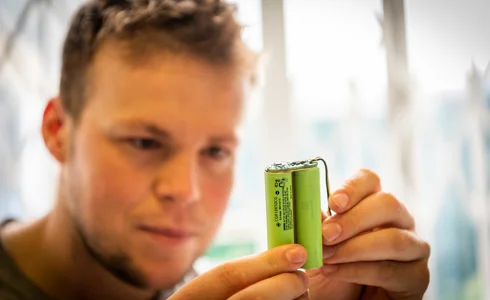 Howard Richard looking at a battery Howard Richard looking at a battery