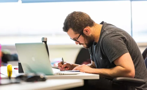 Alex Young working in study room Alex Young working in study room