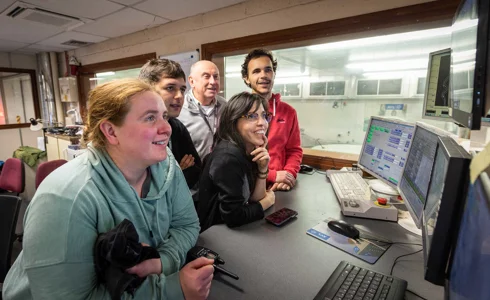 Group of students working in the IAAPS control room Group of students working in the IAAPS control room